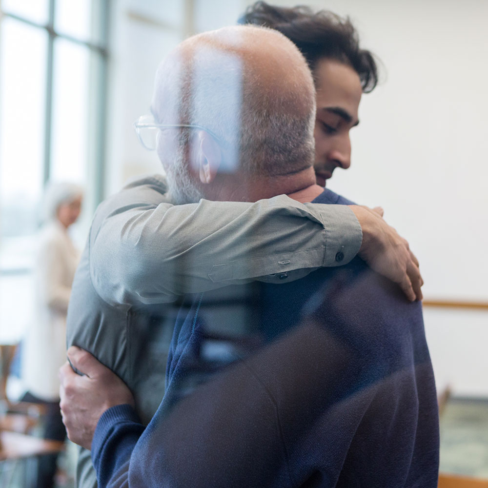 Two men hugging