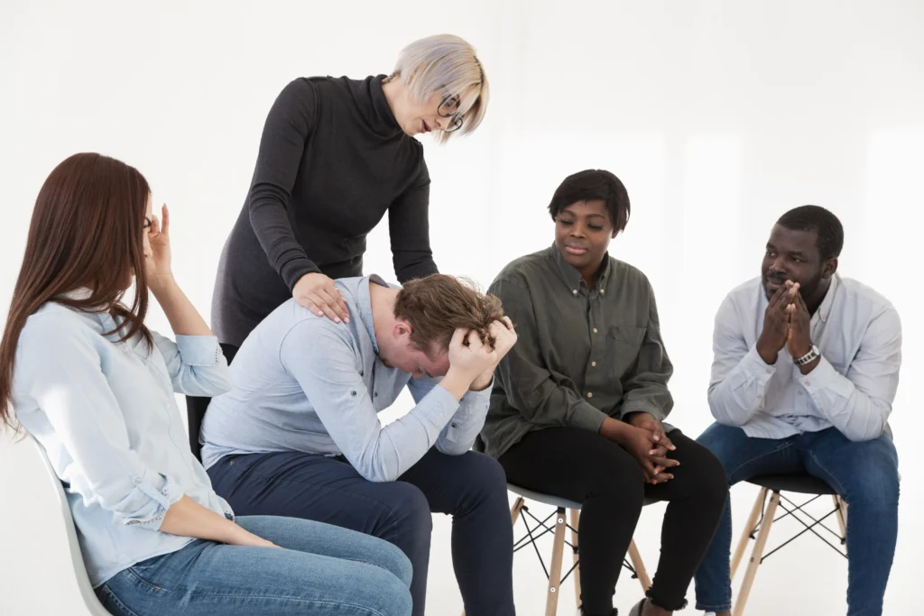 support group with someone in distress being consoled