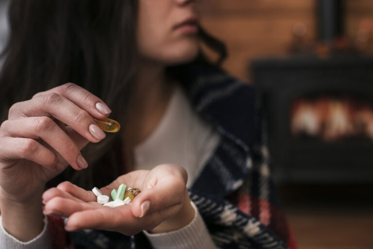 Close up of a woman with medicine in her hand