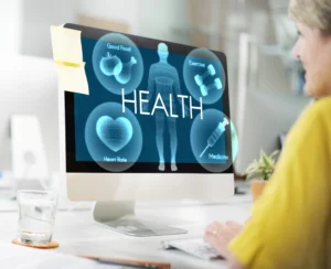 nurse looking at screen showing Good Food, Exercise, Heart Rate and Medicine with the word HEALTH in the middle