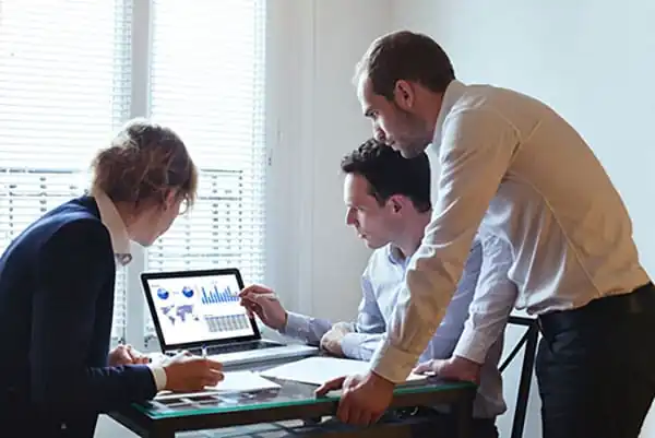 Public health workers looking at electronic health records software on laptop