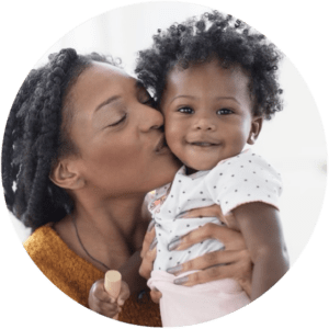 Mother kissing baby girl