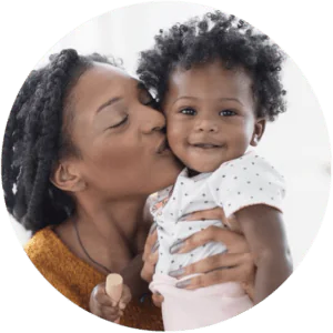 Mother kissing baby girl