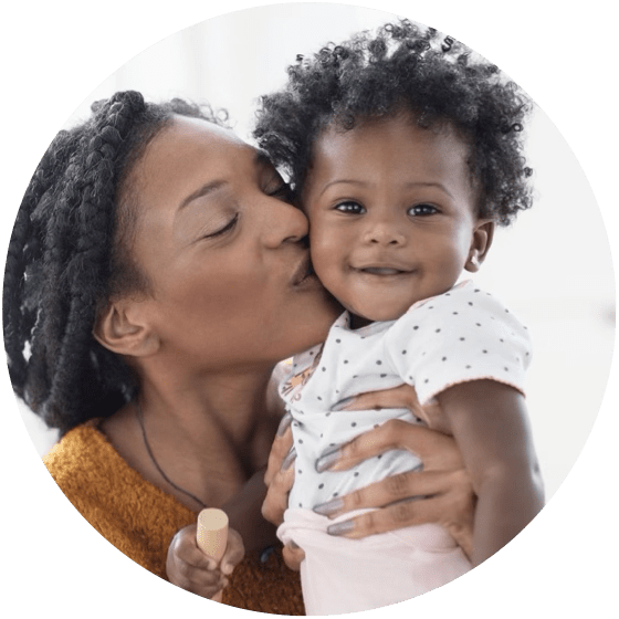 Mother kissing baby girl